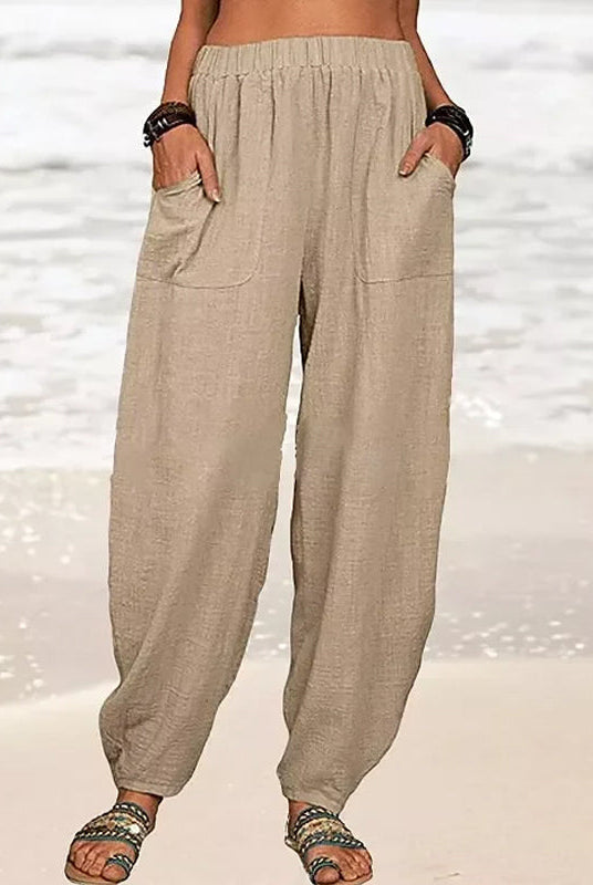 Isabella Lumina black high-waisted harem trousers with casual fit, front pockets and relaxed style, shown on white background.
