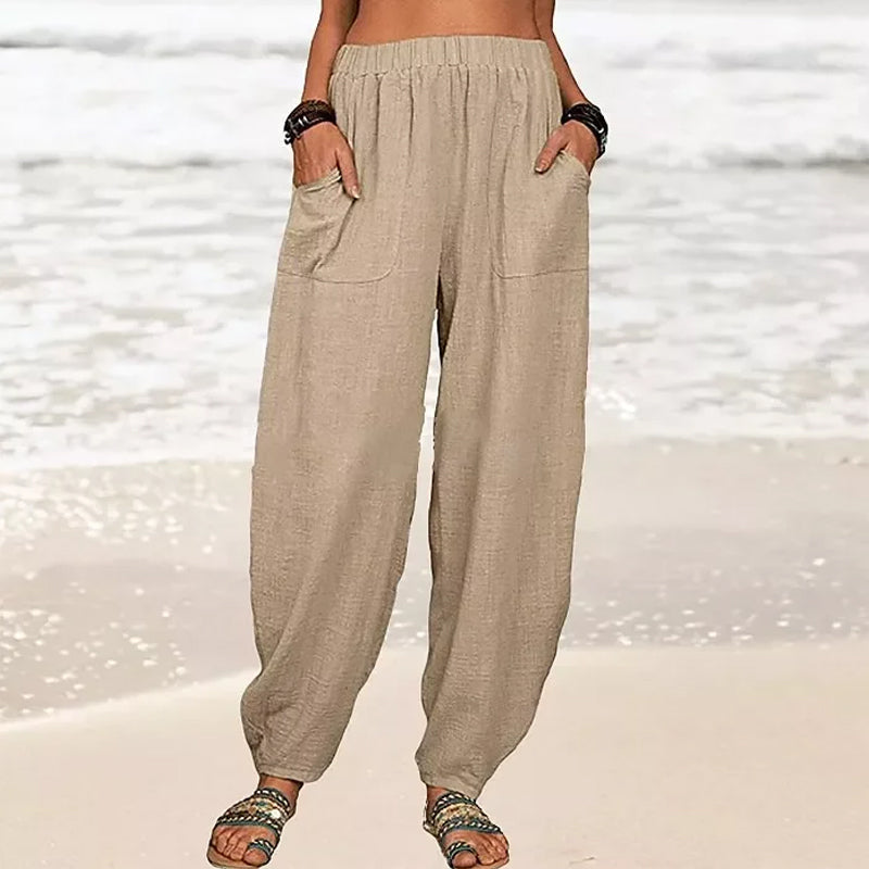 Isabella Lumina black high-waisted harem trousers with casual fit, front pockets and relaxed style, shown on white background.