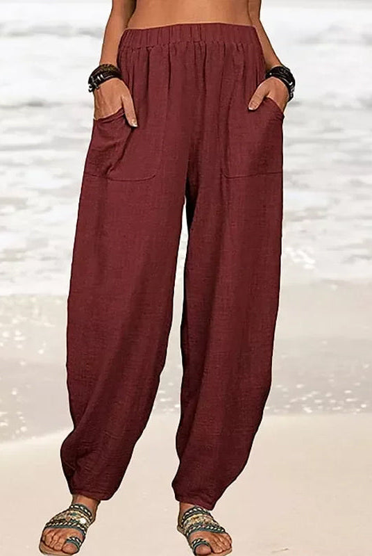 Isabella high-waisted black harem trousers by Lumina Wear with a casual fit and relaxed style, shown in a white background image.