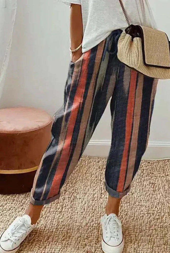 Isabella Lumina Wear grey linen trousers showing a lightweight, breathable fabric, relaxed fit, and modern design.