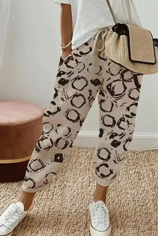 Isabella Lumina Wear lightweight breathable grey linen trousers, relaxed fit, with a natural drape and adjustable waistband.