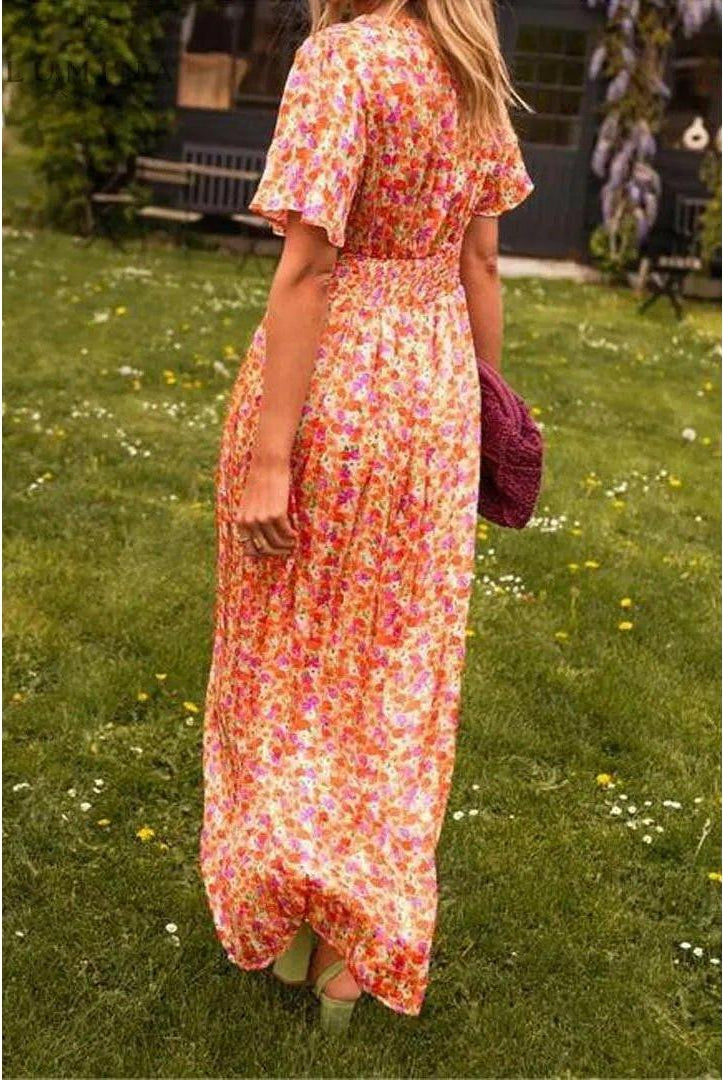 Orange Isabella maxi dress by Lumina Vancouver, elegant wedding guest dress with flowing fabric and stylish design.