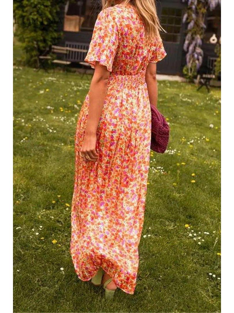 Orange Isabella maxi dress by Lumina Vancouver, elegant wedding guest dress with flowing fabric and stylish design.