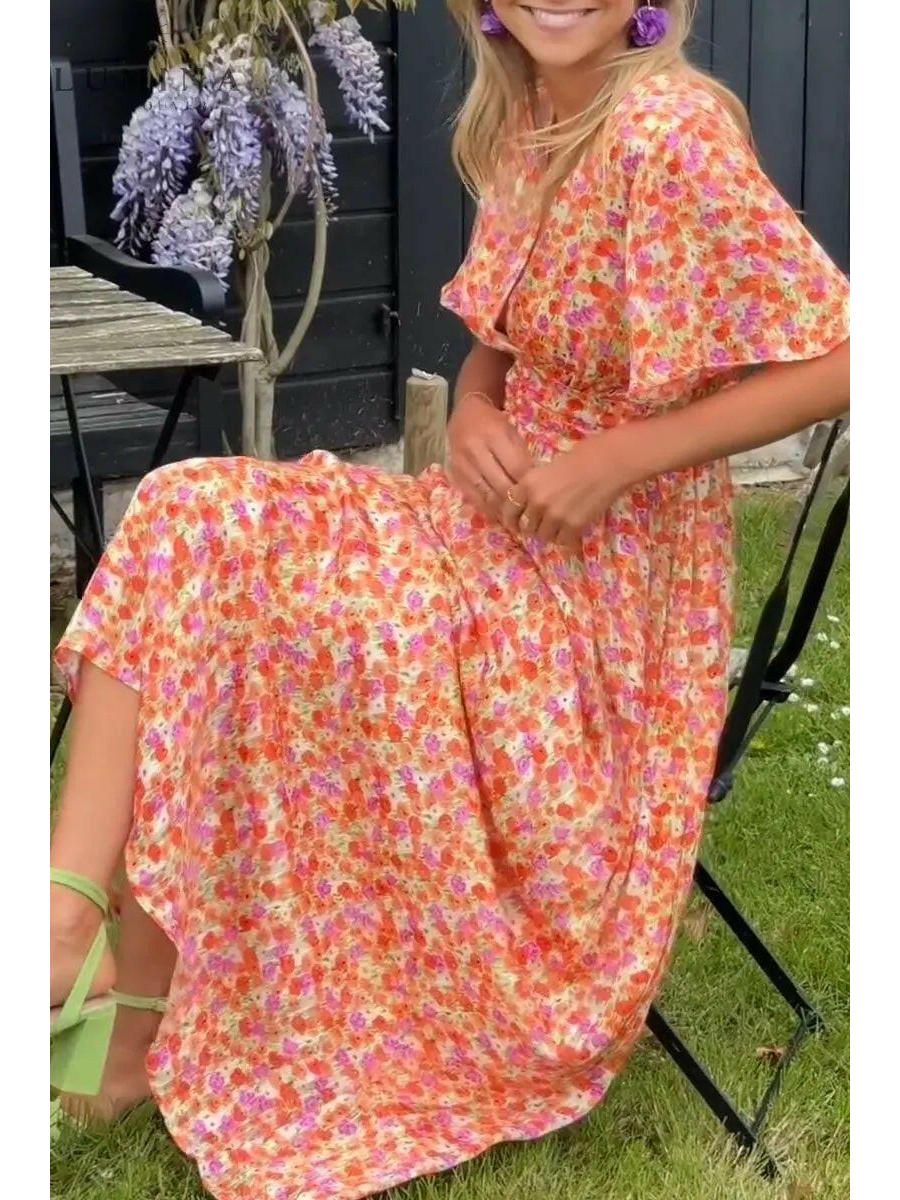 Orange Isabella maxi dress by Lumina Vancouver, perfect for wedding guest attire, shown on a model with elegant styling.