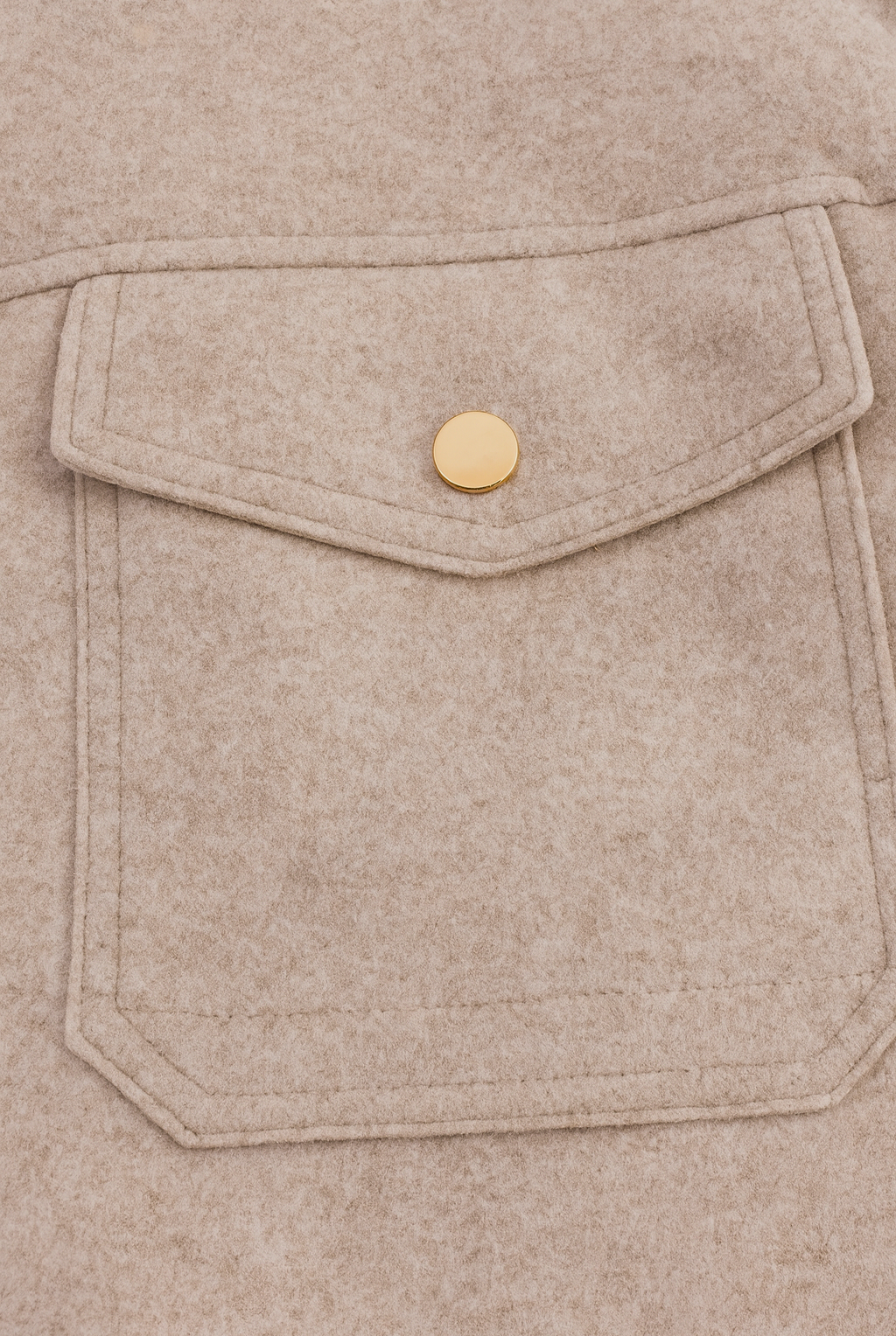 Beige Isabella Lumina Wear modern cropped zip-up jacket with pockets, displayed on a model in a casual outdoor setting.