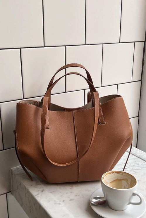 Lumina Wear Isabella oversized vintage handbag with versatile straps, brown leather, and spacious interior for stylish everyday use.