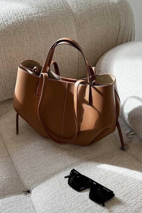 Brown oversized vintage handbag with versatile straps by Lumina Wear, featuring textured leather and spacious interior.