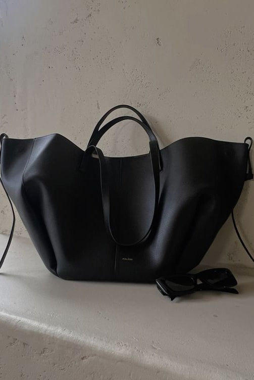 Brown Isabella oversized vintage handbag with versatile straps by Lumina Wear, showing textured leather and adjustable shoulder straps.