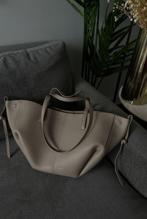 Brown oversized vintage handbag with versatile straps from Lumina Wear, featuring textured leather and spacious interior.