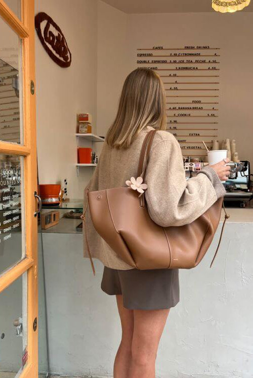 Brown oversized vintage handbag with versatile straps by Lumina Wear, featuring textured leather and spacious interior.
