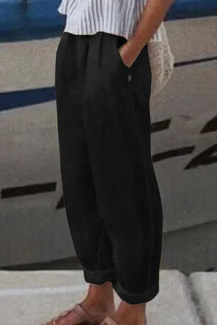 Black Isabella Softline Trousers by Lumina Wear with side pockets, tailored fit, and subtle stitching details.