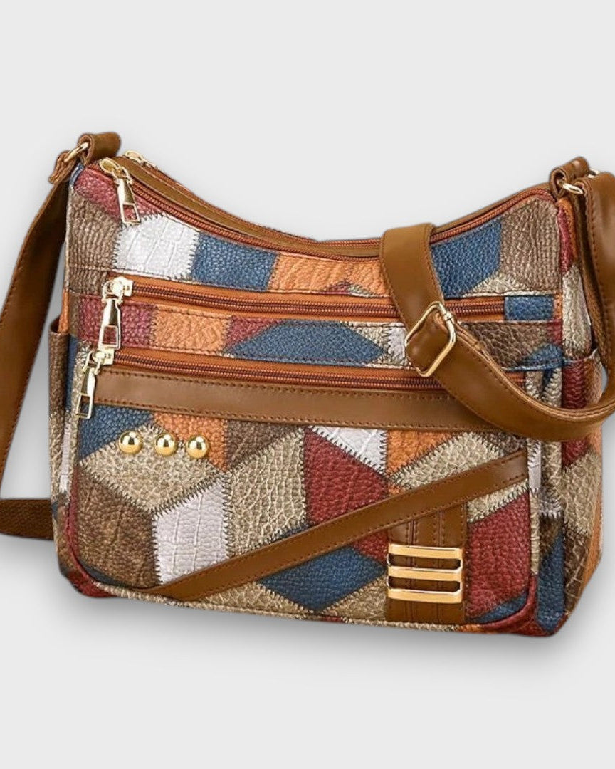 Lumina Wear Isabella textured patchwork shoulder bag with faux-leather accents, featuring a stylish and spacious handbag design.
