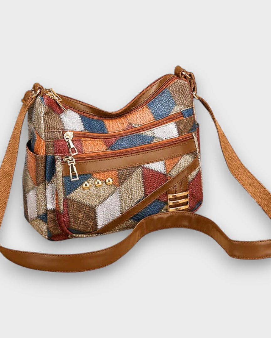 Lumina Wear Isabella textured patchwork shoulder bag with faux-leather accents, showcasing its stylish design and mixed fabric details.
