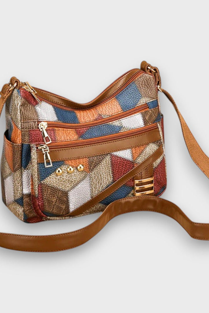Isabella textured patchwork shoulder handbag with faux-leather accents by Lumina Wear, featuring multiple fabric patterns and a shoulder strap.