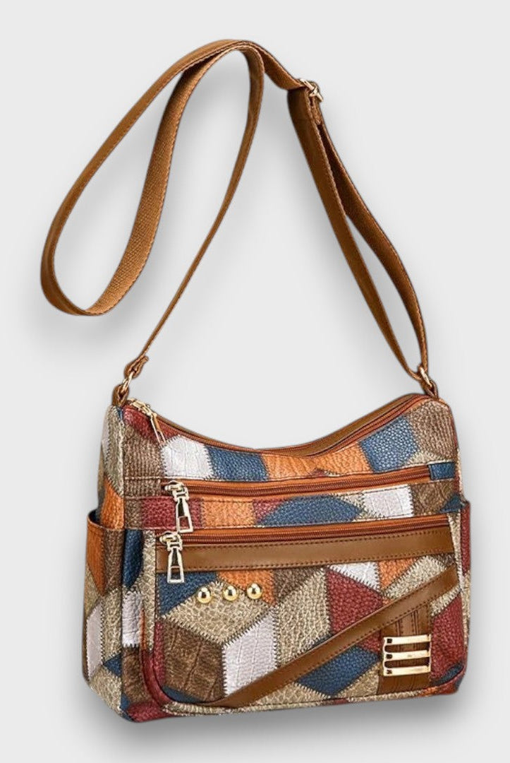 Lumina Wear Isabella textured patchwork shoulder bag with faux-leather accents, featuring a stylish and spacious handbag design.