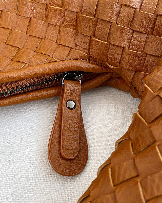 Beige Isabella Lumina woven eco-leather shoulder handbag with unique design, featuring a structured shape and stylish strap detail.