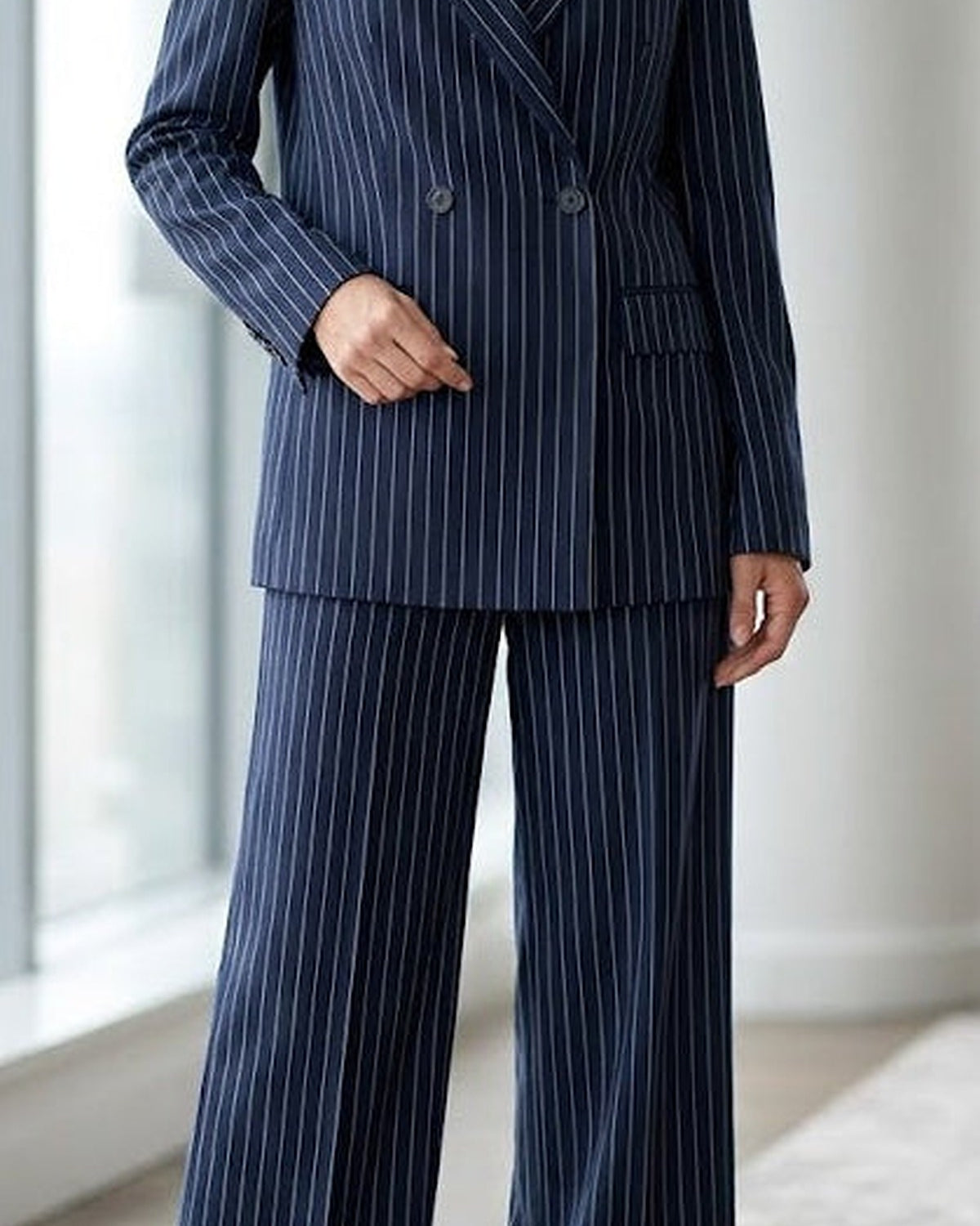 Navy blue Leandra double-breasted suit set by Lumina Wear, featuring tailored blazer and matching trousers on a model.