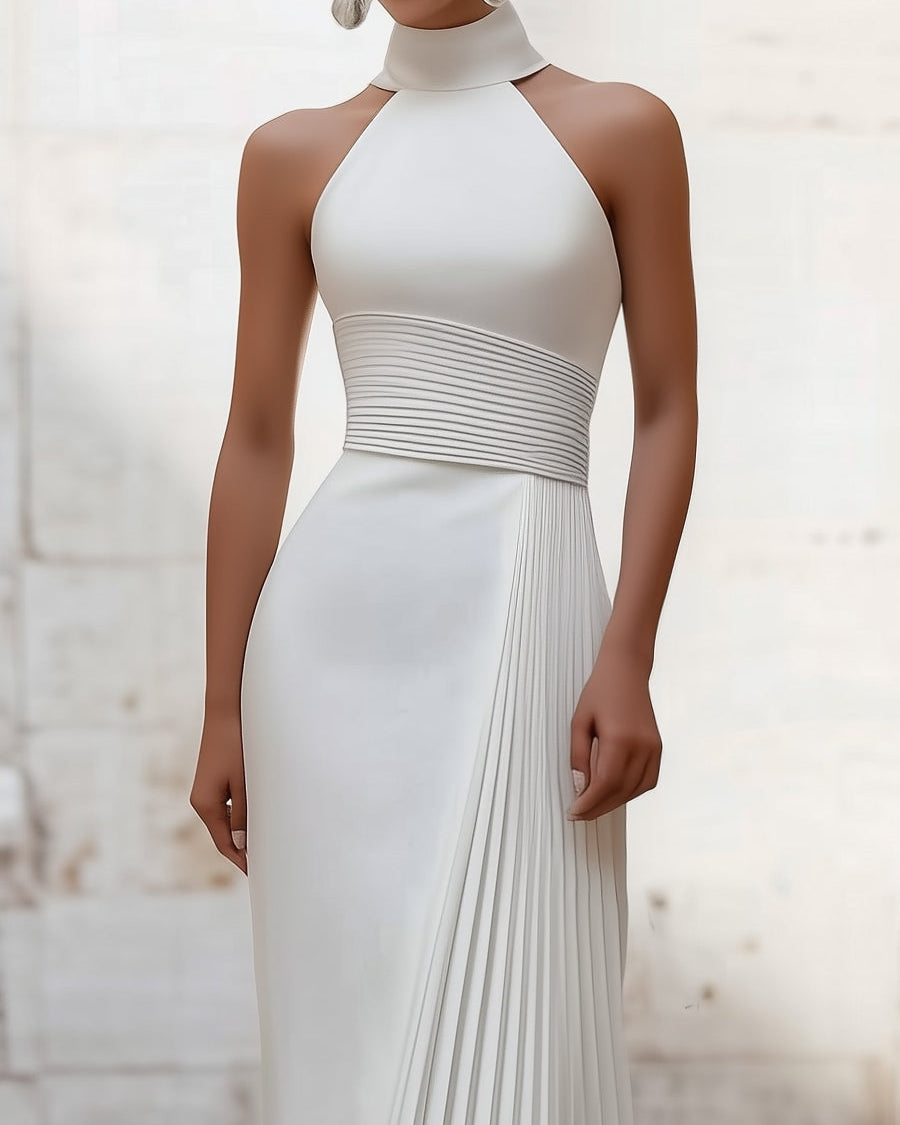 White Isabelle pleated halter-neck gown by Lumina Wear, elegant dress with flowing fabric and stylish design.