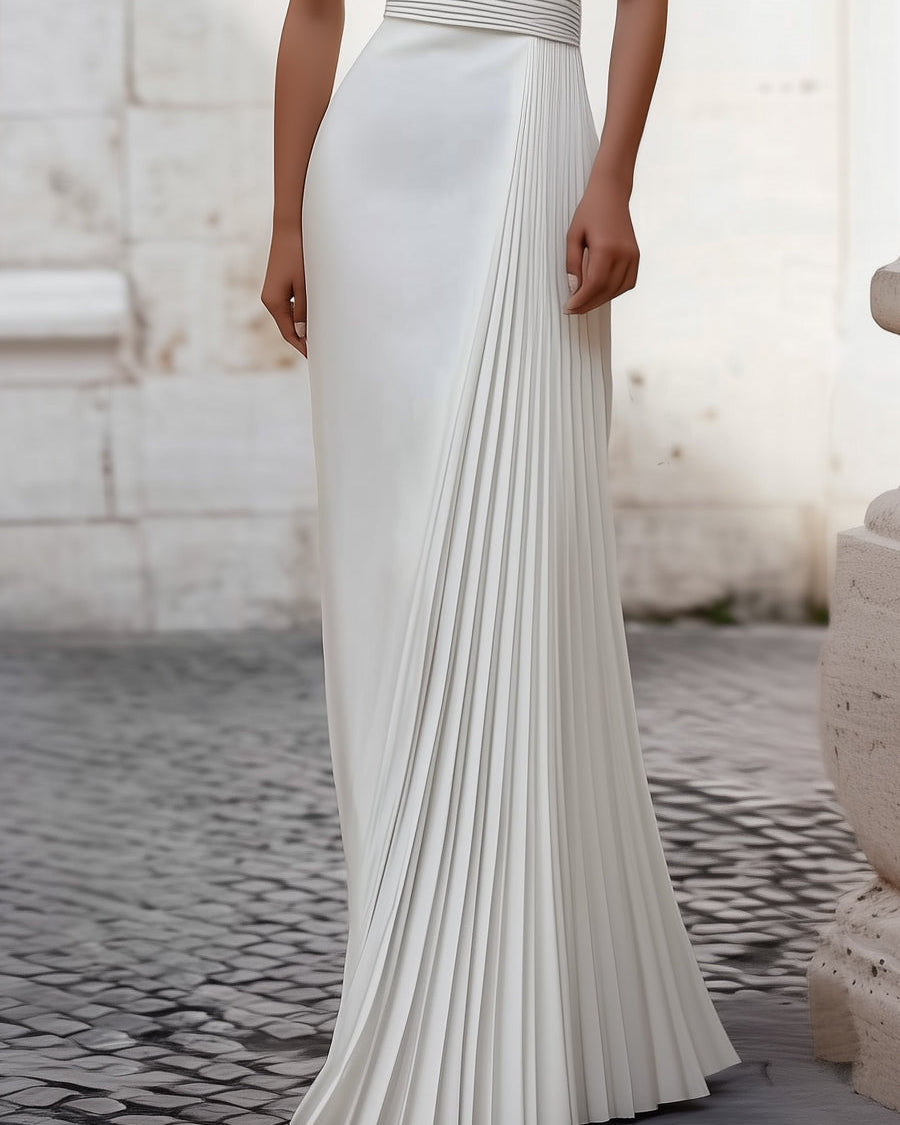 White Isabelle pleated halter-neck gown by Lumina Wear, elegant floor-length dress with a flowing silhouette.