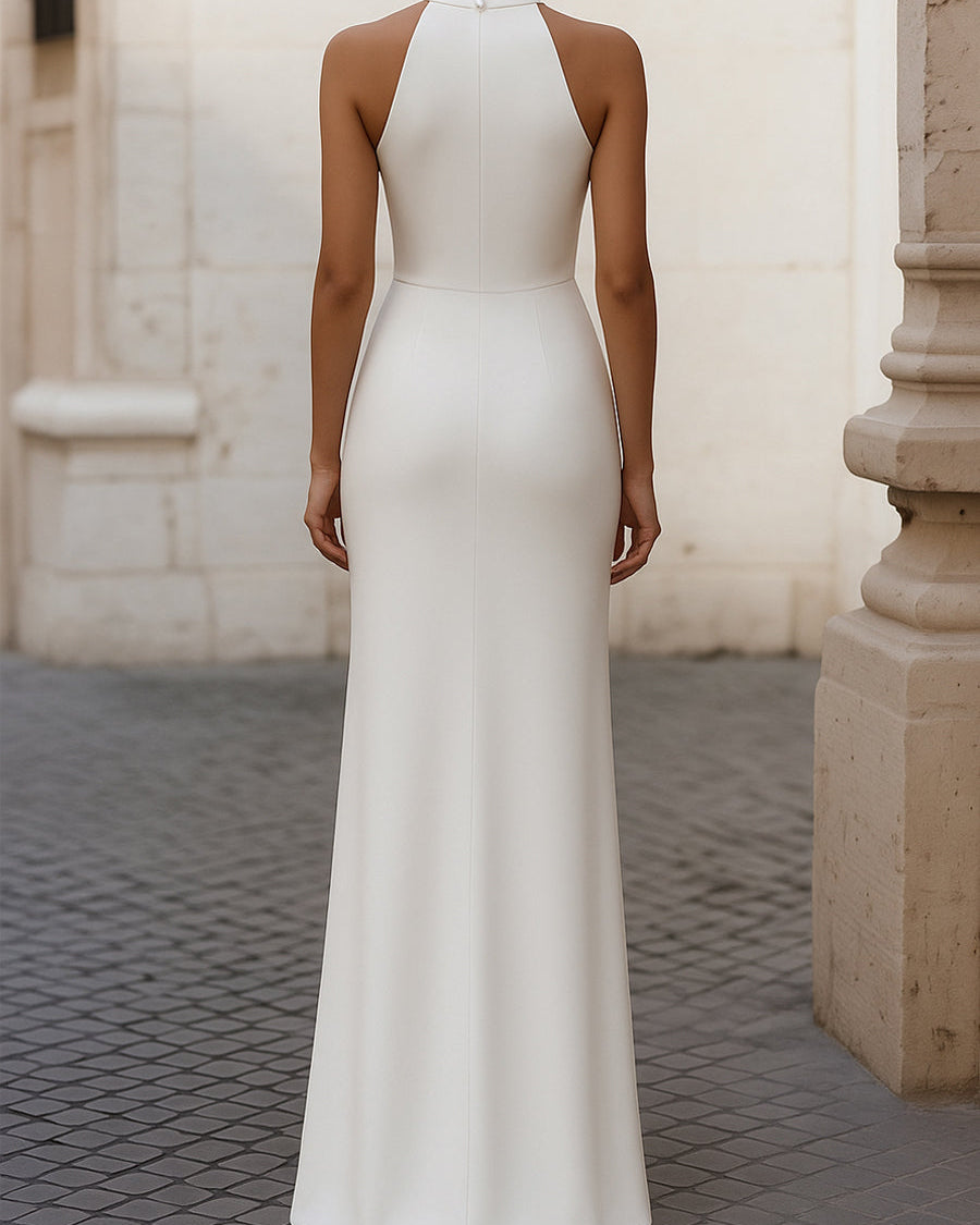 White Isabelle pleated halter-neck gown by Lumina Wear, showcasing elegant design and flowing fabric.