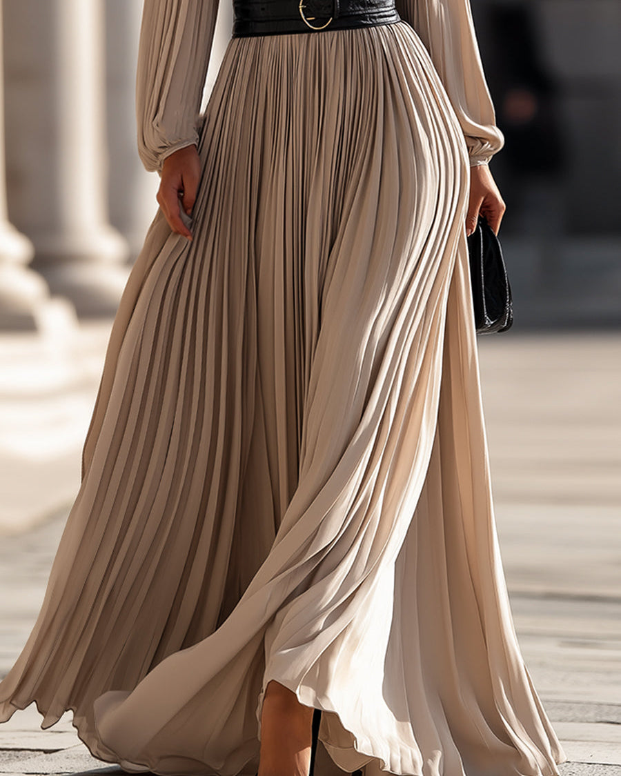 Beige Isabelle pleated high-neck maxi dress by Lumina Wear, displayed on a model, with flowing fabric and elegant design.