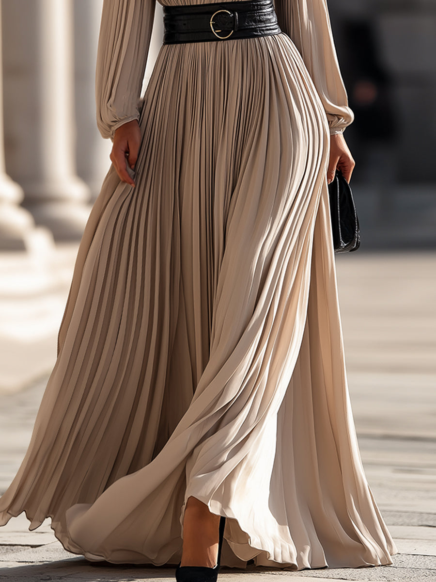 Beige Isabelle pleated high-neck maxi dress by Lumina Wear, displayed on a model, with flowing fabric and elegant design.