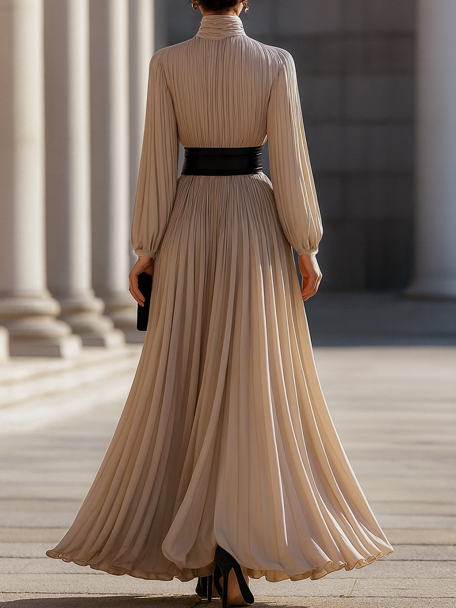 Beige Isabelle pleated high-neck maxi dress by Lumina Wear, shown on a model with flowing fabric and elegant design.