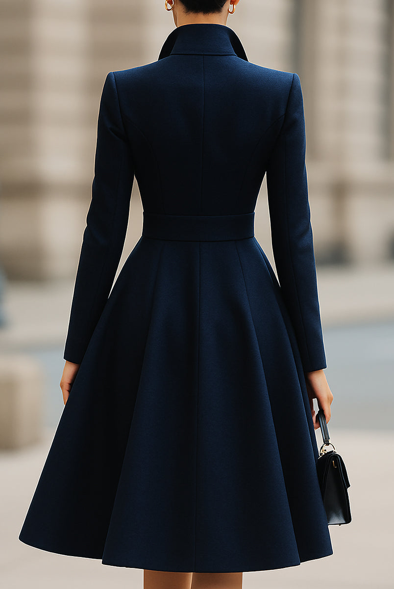 Navy blue Ottavia tailored fit flared peak lapel coat dress by Lumina Vancouver, shown on a model, midi length with structured silhouette.