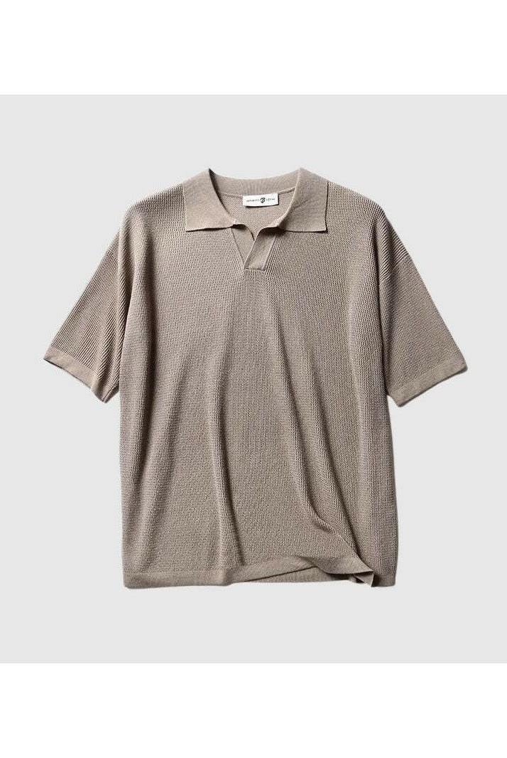 White Jack Washington oversized polo shirt by Lumina Vancouver, displayed on a hanger with a close-up of fabric texture.