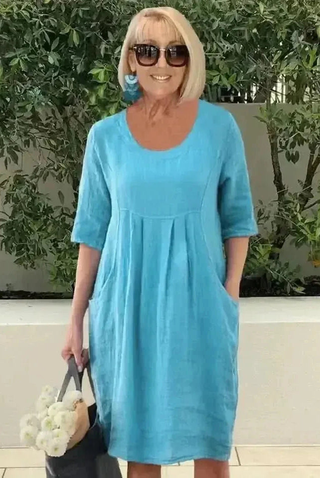 Blue loose dress with pockets by Lumina Wear, featuring a relaxed fit and casual style, shown on a model.