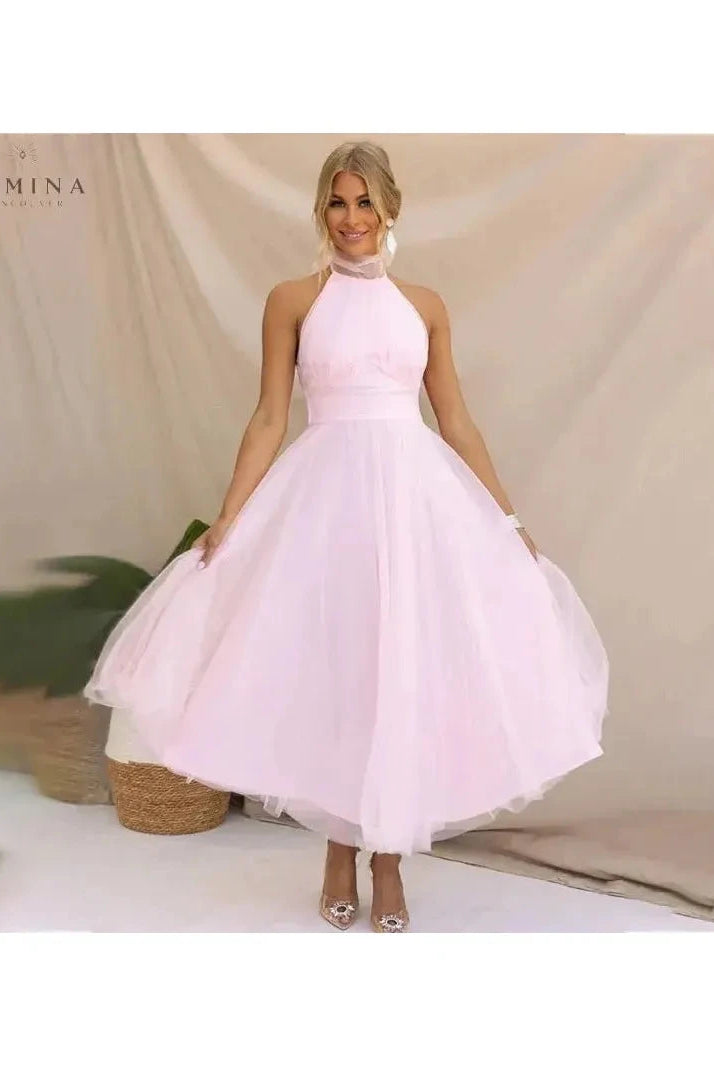 Cream-colored Kaylee fairy evening dress by Lumina Wear, featuring a flowing silhouette and delicate details, perfect for special occasions.