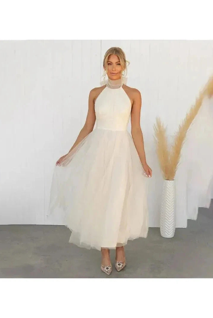 Cream-colored Kaylee Fairy Dress by Lumina Wear, elegant evening dress with delicate details, perfect for wedding guests and special occasions.