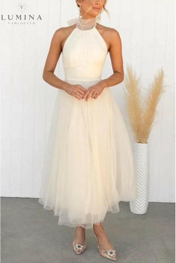 Cream-colored fairy evening dress by Lumina Wear, featuring delicate fabric and whimsical design, perfect for wedding guests or special occasions.
