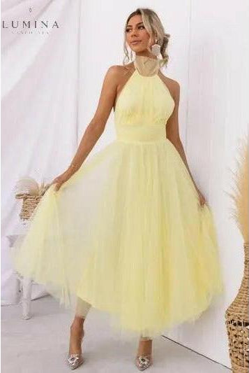 Cream-colored Kaylee fairy evening dress by Lumina Wear, featuring flowing fabric and delicate fairy-inspired design for wedding guests.