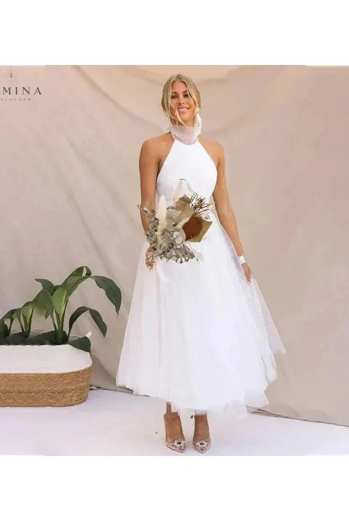 Cream-colored Kaylee Fairy Evening Dress by Lumina Wear featuring delicate fairy-inspired design for wedding guests.