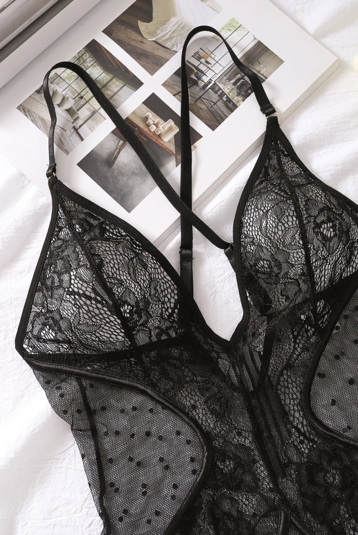 Lumina Wear Keira's Bodysuit, a sleek black bodysuit with long sleeves and fitted design, displayed on a mannequin.