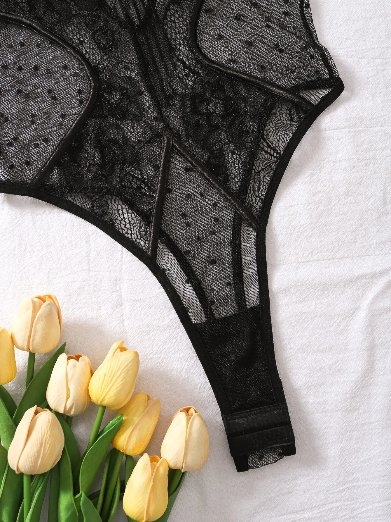 Lumina Vancouver Keira's Bodysuit, close-up of black fitted bodysuit with sleek design and seamless fit.