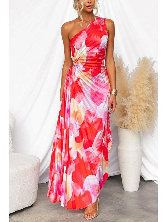 Red Kelsey pleated summer dress by Lumina Vancouver, perfect for wedding guests, shown on a model with flowing fabric.