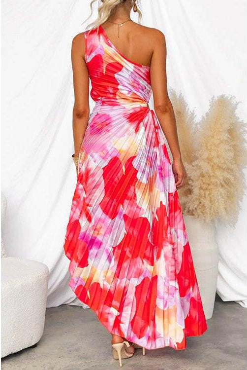 Red Kelsey pleated summer dress by Lumina Wear, shown on a model, perfect for warm-weather occasions and wedding guest attire.