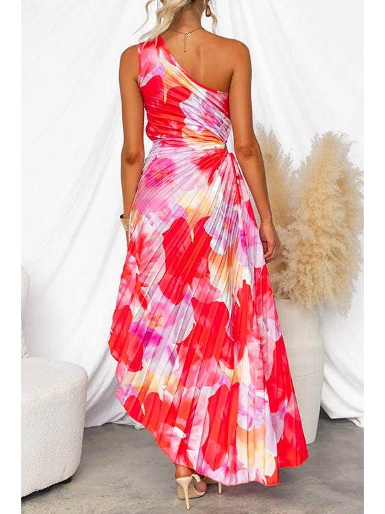 Red Kelsey pleated summer dress by Lumina Vancouver, perfect for wedding guests, shown on a model with flowing fabric.