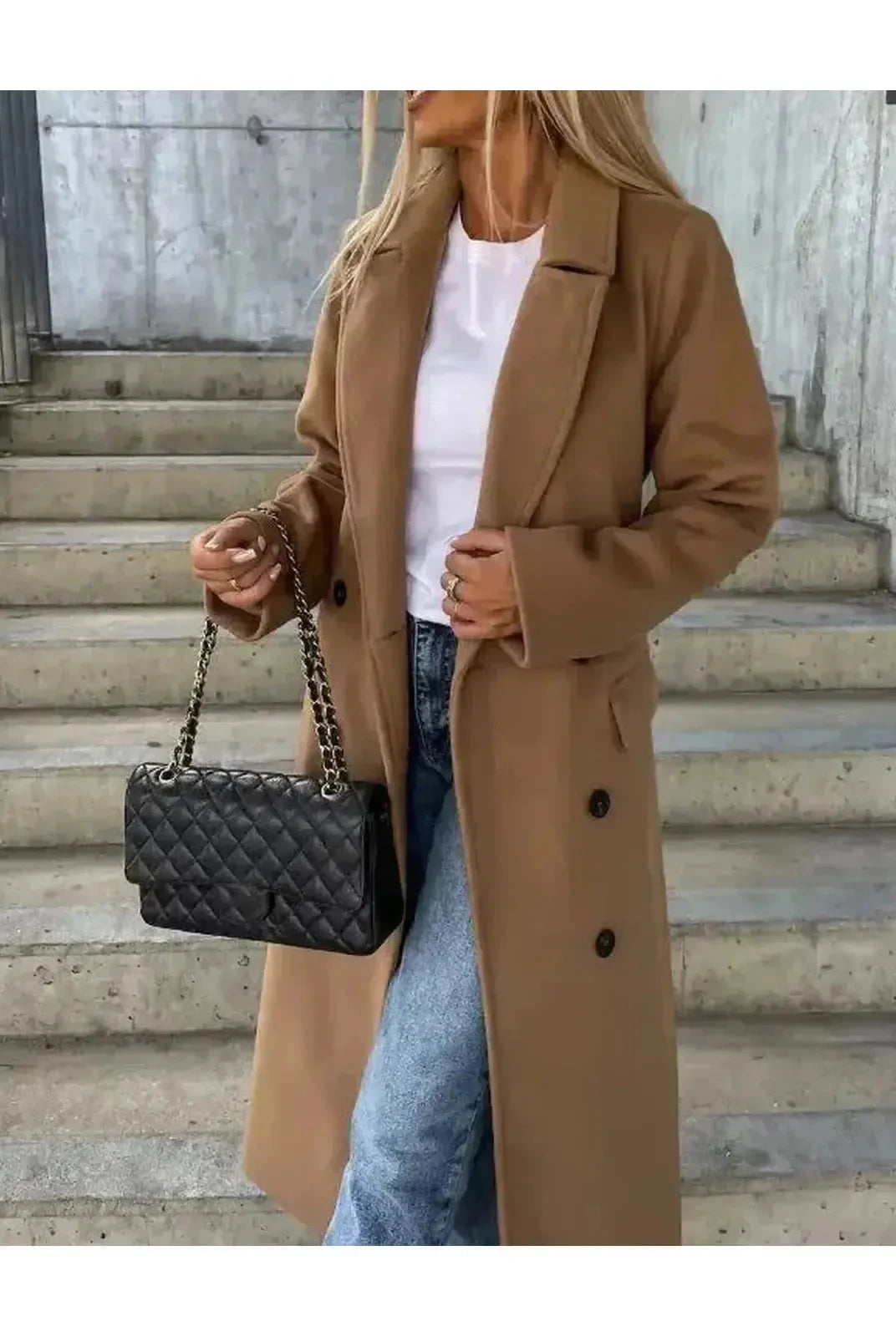 Beige Kim Lumina Vancouver double-breasted wool coat, elegant and stylish, shown hanging on a wooden rack.