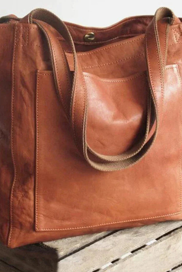 Elegant black leather handbag by Lumina Wear with spacious interior, featuring a stylish design and brown accents.