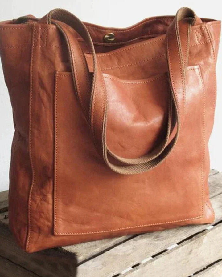 Elegant black leather handbag by Lumina Wear featuring a spacious interior and stylish design, perfect for daily use.