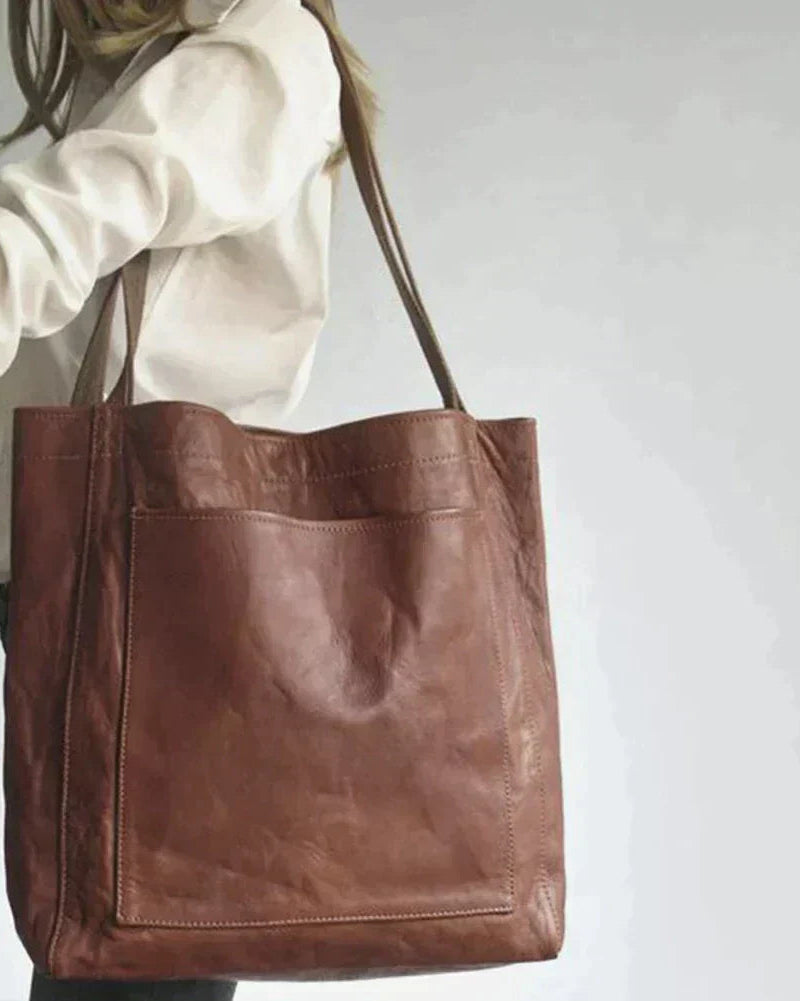 Lumina Wear Lauren black leather handbag with spacious interior, stylish design, and brown accents, measuring 36x13x42cm.