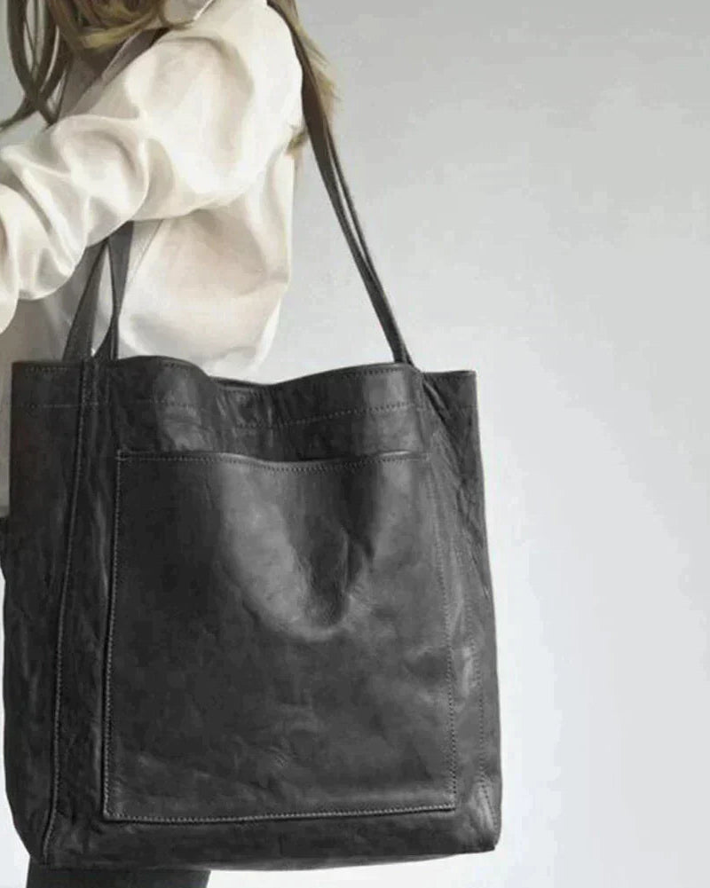 Elegant black leather handbag by Lumina Wear featuring a spacious interior and stylish design, perfect for everyday use.