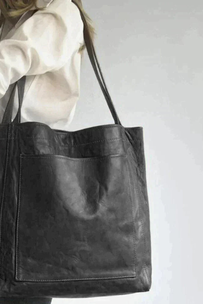 Elegant black leather handbag by Lumina Wear with spacious interior and stylish design, perfect for daily use.