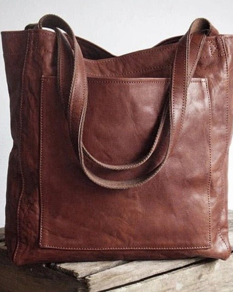 Elegant black leather handbag by Lumina Wear featuring a spacious interior and stylish design.