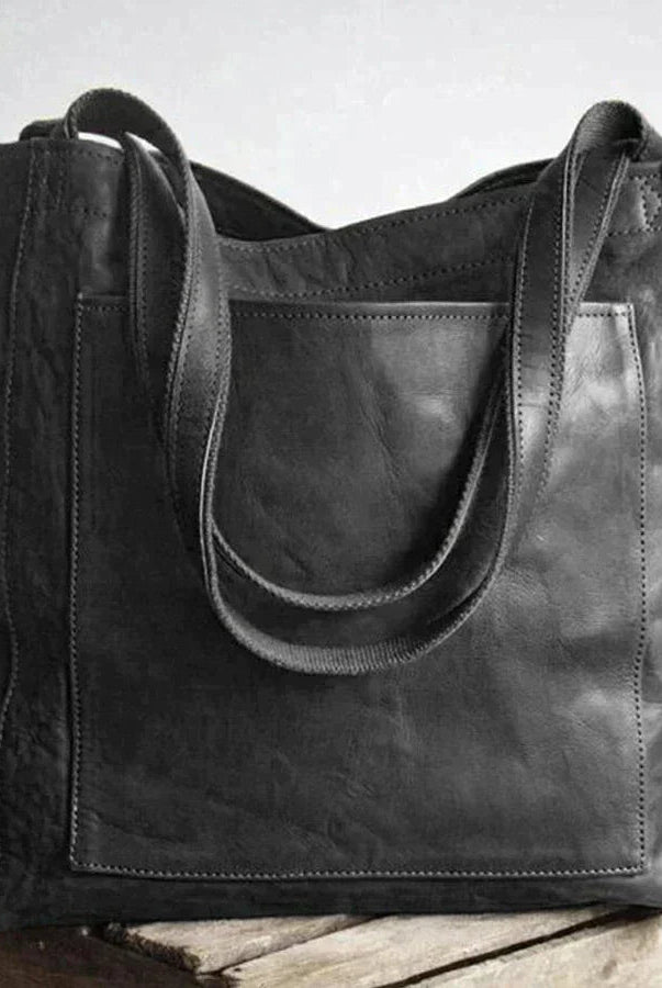 Elegant black leather handbag by Lumina Wear, showcasing spacious interior and stylish design, perfect for everyday use.