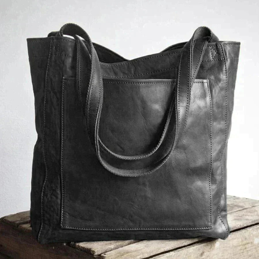 Elegant black leather handbag by Lumina Wear, showcasing spacious interior and stylish design, perfect for everyday use.