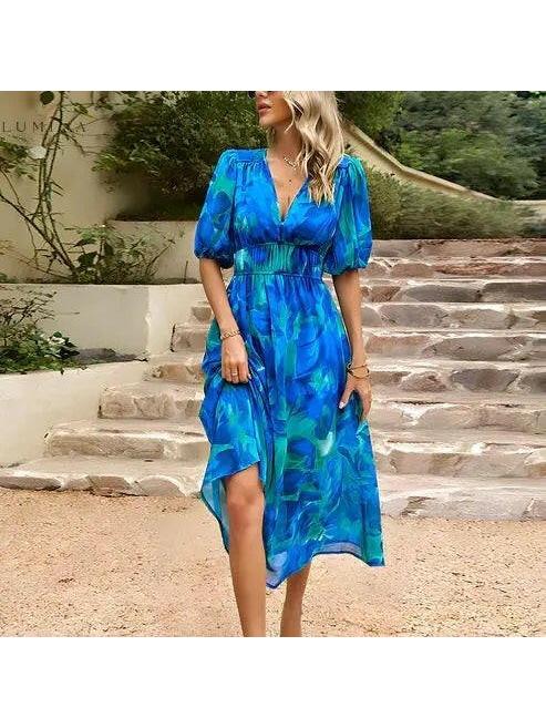 Blue Leona elegant midi dress by Lumina Vancouver, perfect for wedding guests, shown with a flowy silhouette and stylish design.